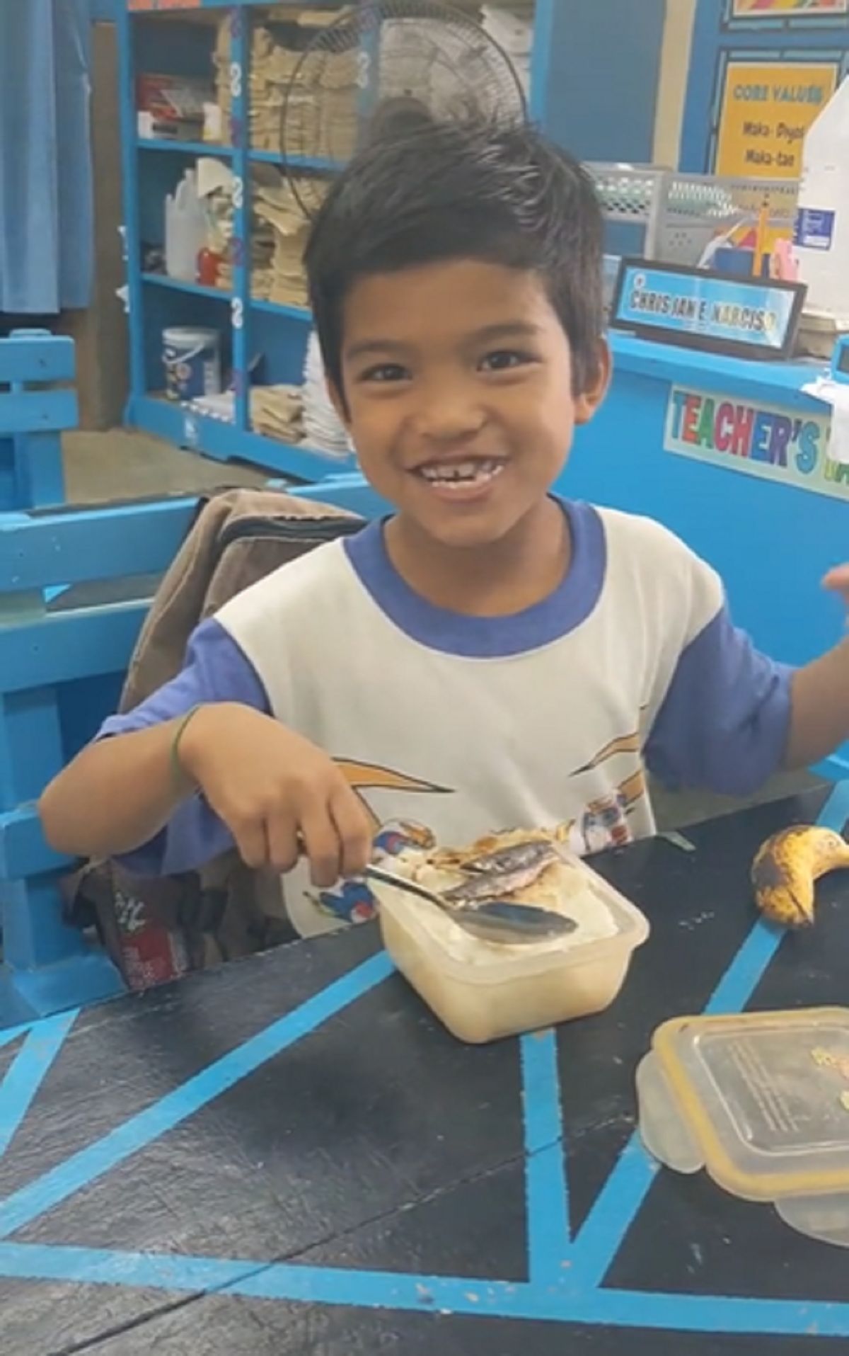 students happily eating dried fish